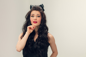 Image showing Portrait of beautiful young woman isolated on grey studio background