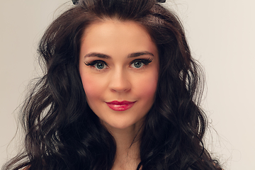 Image showing Close up portrait of beautiful young woman isolated on grey studio background