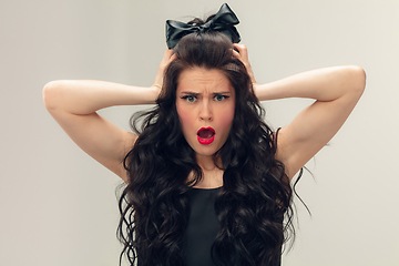 Image showing Portrait of beautiful young woman isolated on grey studio background