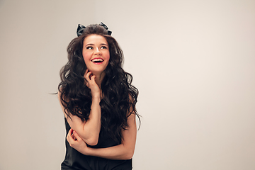 Image showing Portrait of beautiful young woman isolated on grey studio background