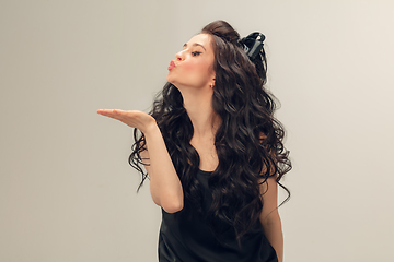 Image showing Portrait of beautiful young woman isolated on grey studio background