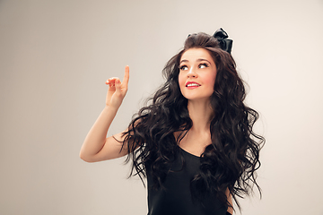 Image showing Portrait of beautiful young woman isolated on grey studio background