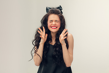 Image showing Portrait of beautiful young woman isolated on grey studio background