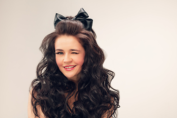 Image showing Portrait of beautiful young woman isolated on grey studio background