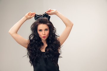 Image showing Portrait of beautiful young woman isolated on grey studio background