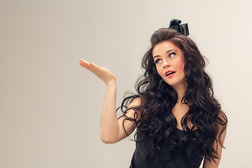 Image showing Portrait of beautiful young woman isolated on grey studio background