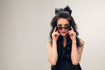 Image showing Portrait of beautiful young woman isolated on grey studio background