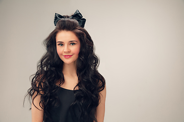 Image showing Portrait of beautiful young woman isolated on grey studio background