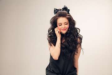 Image showing Portrait of beautiful young woman isolated on grey studio background