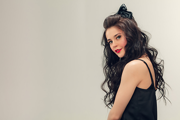 Image showing Portrait of beautiful young woman isolated on grey studio background