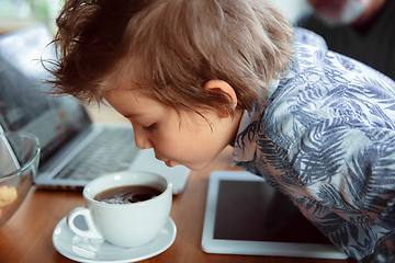 Image showing Grandfather and his grandson spending time insulated at home, stadying, watching cinema, shopping together