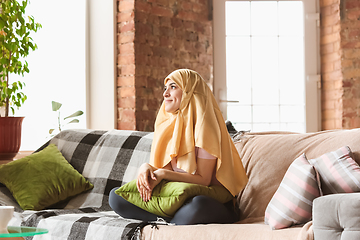 Image showing A pretty young muslim woman at home during quarantine and self-insulation