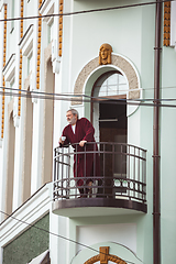 Image showing Mature senior older man during quarantine, realizing how important stay at home during virus outbreak, drinking coffee on the balcony