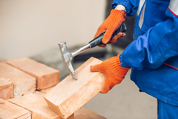 Image showing Close up of hands of repairman, professional builder working outdoors, repairing