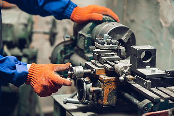 Image showing Close up of hands of repairman, professional builder working outdoors, repairing