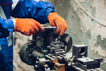 Image showing Close up of hands of repairman, professional builder working outdoors, repairing