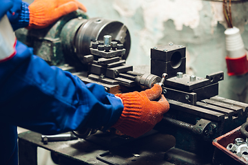 Image showing Close up of hands of repairman, professional builder working outdoors, repairing