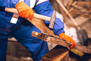 Image showing Close up of hands of repairman, professional builder working outdoors, repairing