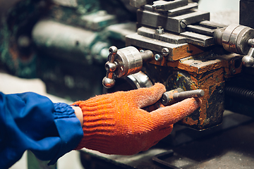 Image showing Close up of hands of repairman, professional builder working outdoors, repairing