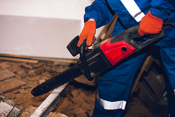 Image showing Close up of hands of repairman, professional builder working outdoors, repairing