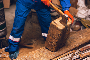 Image showing Close up of hands of repairman, professional builder working outdoors, repairing