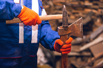 Image showing Close up of hands of repairman, professional builder working outdoors, repairing