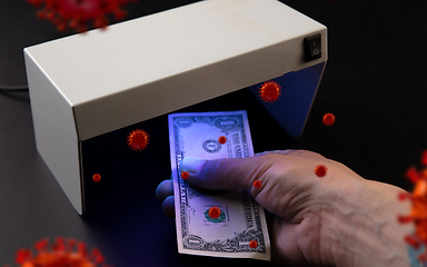 Image showing Male hands checking of banknotes in the detector, 3D models of coronavirus spreding around