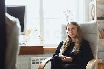 Image showing Young woman sitting in office during the job interview with female employee, boss or HR-manager, talking, thinking, looks confident