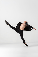 Image showing Young and graceful ballet dancer in minimal black style isolated on white studio background