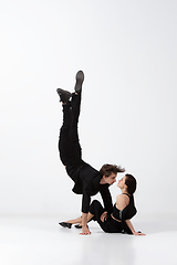 Image showing Young and graceful ballet dancers in minimal black style isolated on white studio background