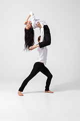 Image showing Young and graceful ballet dancers in minimal black style isolated on white studio background