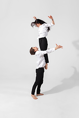 Image showing Young and graceful ballet dancers in minimal black style isolated on white studio background