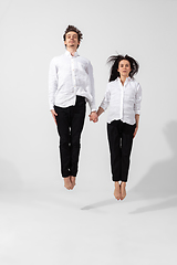 Image showing Young and graceful ballet dancers in minimal black style isolated on white studio background