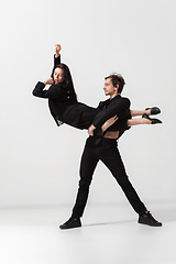 Image showing Young and graceful ballet dancers in minimal black style isolated on white studio background