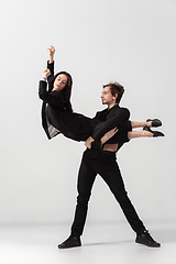 Image showing Young and graceful ballet dancers in minimal black style isolated on white studio background