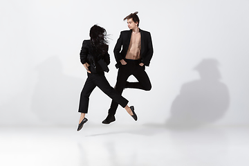 Image showing Young and graceful ballet dancers in minimal black style isolated on white studio background