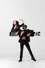 Image showing Young and graceful ballet dancers in minimal black style isolated on white studio background