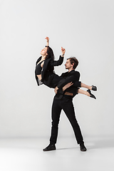 Image showing Young and graceful ballet dancers in minimal black style isolated on white studio background