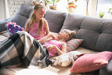 Image showing Quiet little girls waking up in a bedroom in cute pajamas, home style and comfort