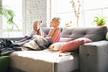 Image showing Quiet little girls waking up in a bedroom in cute pajamas, home style and comfort