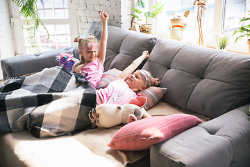 Image showing Quiet little girls waking up in a bedroom in cute pajamas, home style and comfort