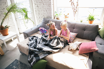 Image showing Quiet little girls waking up in a bedroom in cute pajamas, home style and comfort