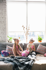 Image showing Quiet little girls waking up in a bedroom in cute pajamas, home style and comfort