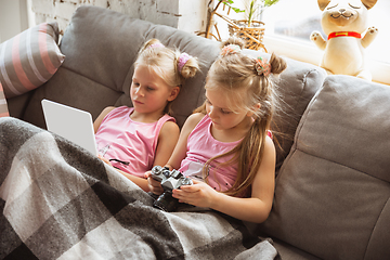 Image showing Quiet little girls playing in a bedroom in cute pajamas, home style and comfort, watching cartoons, cinema, having fun