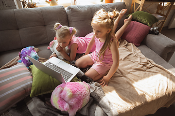 Image showing Quiet little girls playing in a bedroom in cute pajamas, home style and comfort, watching cartoons, cinema, having fun