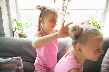 Image showing Quiet little girls playing in a bedroom in cute pajamas, home style and comfort, making a hairstyle