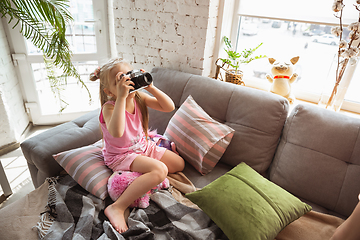 Image showing Little girl playing in a bedroom in cute pajama, home style and comfort, taking a photo, having fun