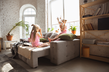 Image showing Quiet little girls playing in a bedroom in cute pajamas, home style and comfort, taking a photo