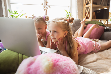 Image showing Quiet little girls playing in a bedroom in cute pajamas, home style and comfort, watching cartoons, cinema, having fun