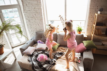 Image showing Quiet little girls playing in a bedroom in cute pajamas, home style and comfort, taking a photo, having fun